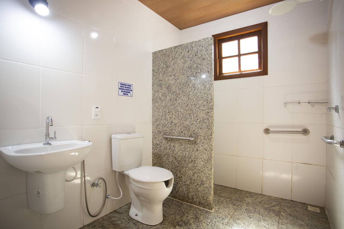A bathroom with a sink, toilet, and shower.