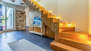 A modern staircase with glass railings and wooden steps, leading to a second floor. - Awesome home in Banjole (Banjole)