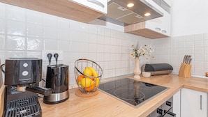 A modern kitchen with a coffee maker, toaster, and fruit basket on the counter. - 3 bedroom beautiful home in Rogoznica (Rogoznica)