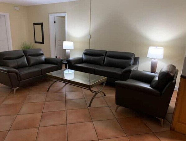 Relax in this stylish living room with two comfortable sofas and a glass coffee table.