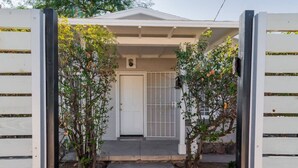 A house with a white exterior, a front door, and a small porch area.