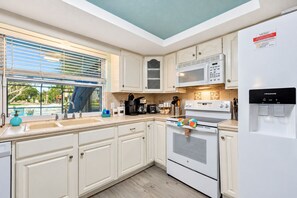 The contemporary design is complemented by top-of-the-line appliances, ensuring that every cooking endeavor is met with efficiency and style. - Cozy Oasis Screened Pool Picturesque Water Canal Views! (Port Richey)