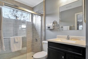 Shower, hair dryer, towels, toilet paper