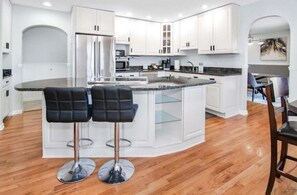 Enjoy cooking in this well-equipped kitchen with a central island and stainless steel appliances.