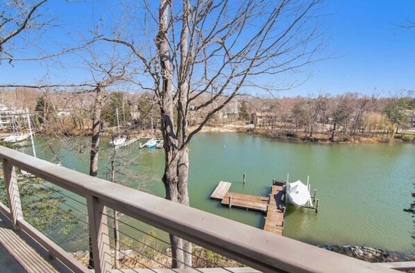 Guests can enjoy a serene lakeside view from a walkway with a clear view of the calm water.