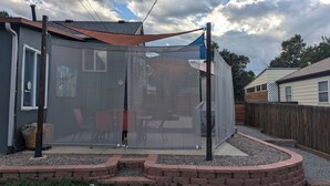 A backyard with a covered patio area, a wooden fence, and a brick border. - Cannabis Friendly House Minutes From Downtown Denver & Red Rocks (Denver)