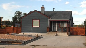 A two-story house with a dark gray exterior, a red roof, and a small front porch. - Cannabis Friendly House Minutes From Downtown Denver & Red Rocks (Denver)