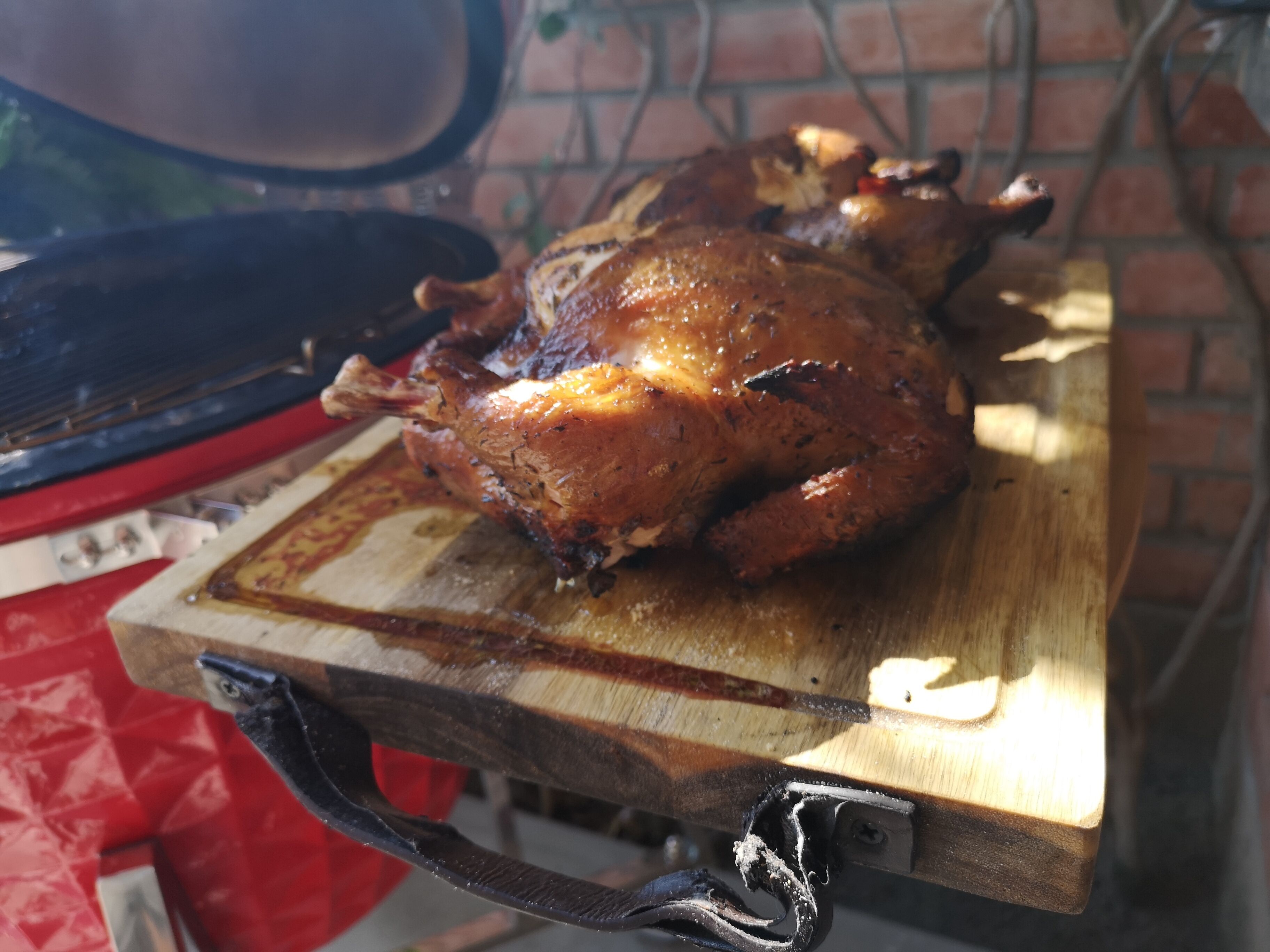 Un poulet rôti sur une planche à découper en bois.