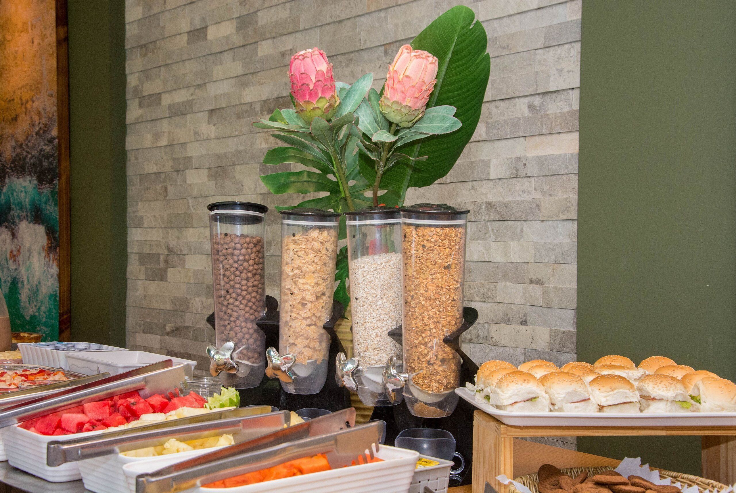 A buffet with various food items, including fruits, vegetables, and sandwiches.