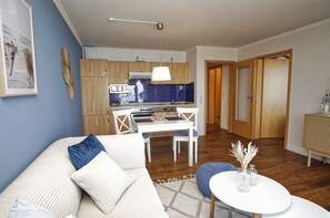 A compact living space with a kitchenette, a dining area, and a seating area.