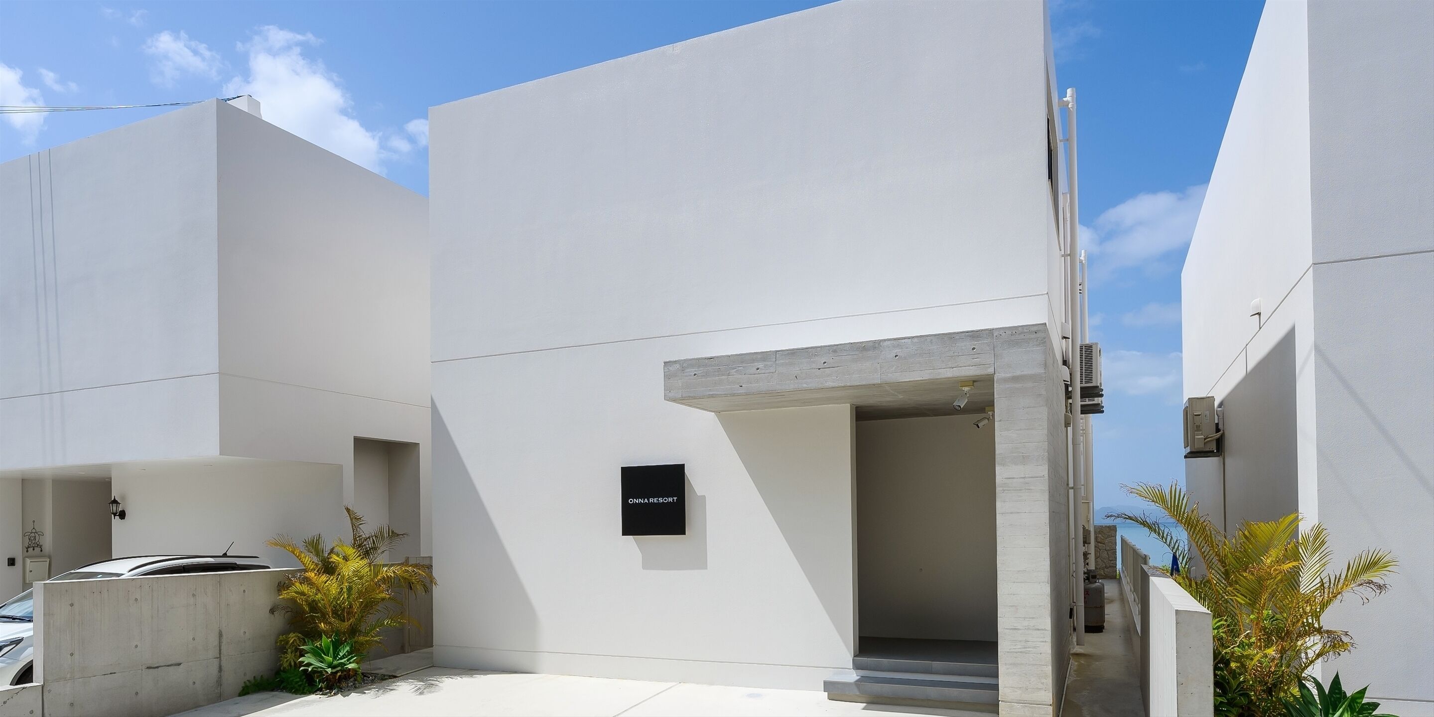 A modern building with a minimalist design, featuring a prominent entrance with a sign reading "ONNARESORT".