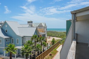 A coastal property with multiple buildings, a beach, and a clear view of the ocean.