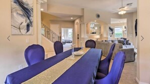 A dining area with a long table, chairs, and a decorative runner.