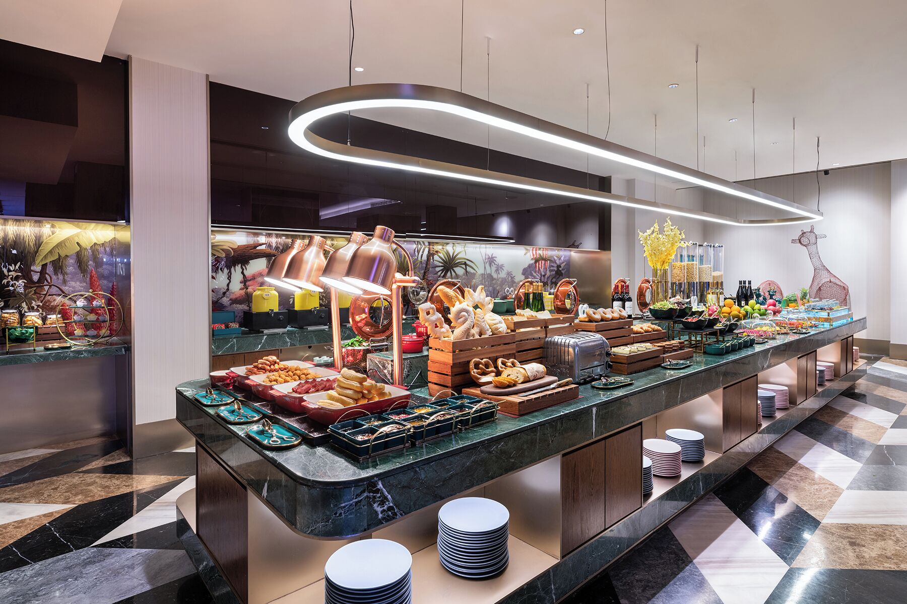 A buffet with various food items and a modern interior design.
