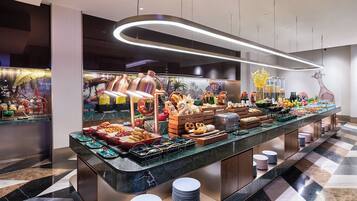 A buffet with various food items and a modern interior design.