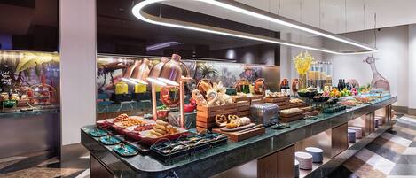 A buffet with various food items and a modern interior design.