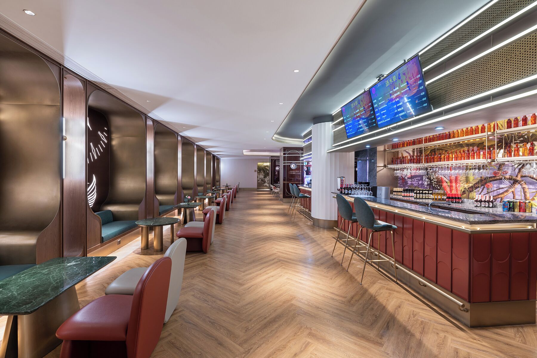 A modern bar area with seating and a digital menu display.
