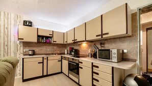 A compact kitchen with a microwave, coffee maker, and a toaster on the counter. - "Pesch" Holiday Apartment with Shared Terrace (Nettersheim -Pesch)