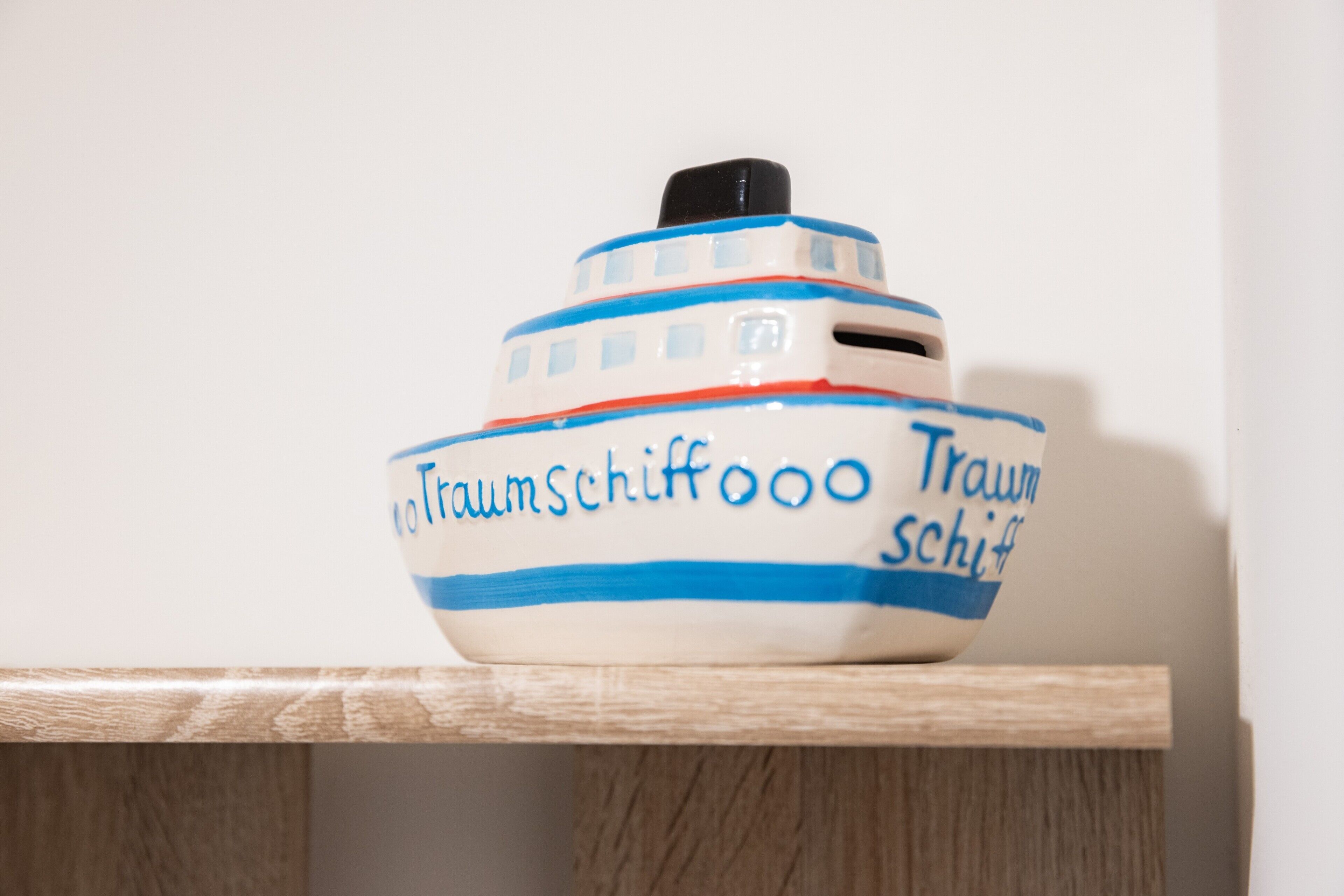 A ceramic boat with the text 'Traum Schiff' on it.