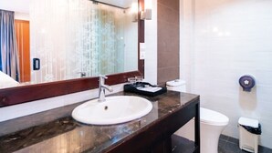 A modern bathroom with a marble sink, a large mirror, and a toilet. - New Champa Boutique Hotel (Vientiane)