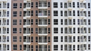 A multi-story building with a repeating pattern of balconies and windows. - Modern Studio Room At Tokyo Riverside Pik 2 Apartment (Teluknaga)