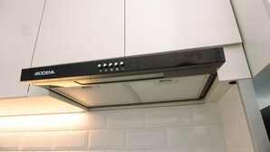 A kitchen hood with control buttons and a vent. - Cozy Stay Studio At Urbantown Serpong Apartment (South Tangerang)