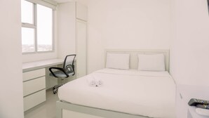 A bedroom with a bed, a desk, a chair, and a window. - Cozy Stay Studio At Urbantown Serpong Apartment (South Tangerang)