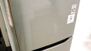 A stainless steel LG refrigerator with a digital display and a water dispenser. - Cozy Stay Studio At Urbantown Serpong Apartment (South Tangerang)