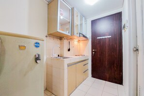 Apartment | Private kitchen | Full-size fridge, stovetop - Homey And Tidy Studio Serpong Greenview Apartment (South Tangerang)