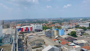 A high-rise building with a view of a cityscape. - Homey And Cozy Stay Studio Margonda Residence 3 Apartment (Depok)