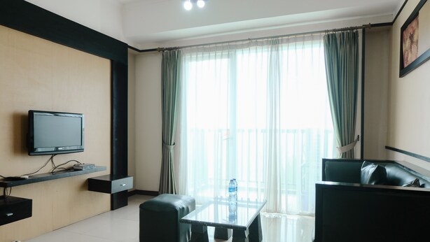 A modern living room with a flat-screen TV, a glass coffee table, and a sofa. - Simply 2Br (No Kitchen) At Apartment Marbella Suites Dago Pakar Bandung (Bandung)