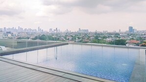 A rooftop pool with a city skyline view.