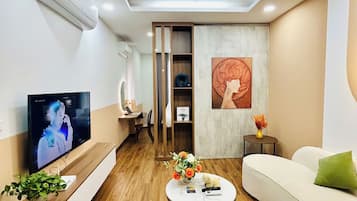 Deluxe Apartment | Living area | Flat-screen TV, fireplace