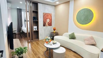 Deluxe Apartment | Living area | Flat-screen TV, fireplace