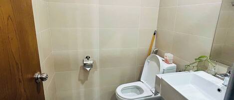 Un baño pequeño con inodoro, lavabo y espejo.