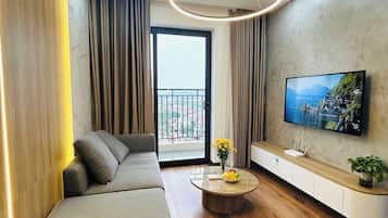 Luxury Apartment | Living area | Flat-screen TV, fireplace
