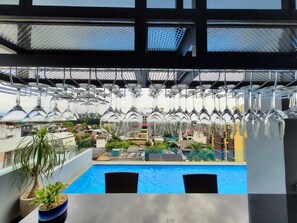 A rooftop pool area with a view of a building in the background. - Ama's House Luxury Boutique Hotel (Chiang Mai)