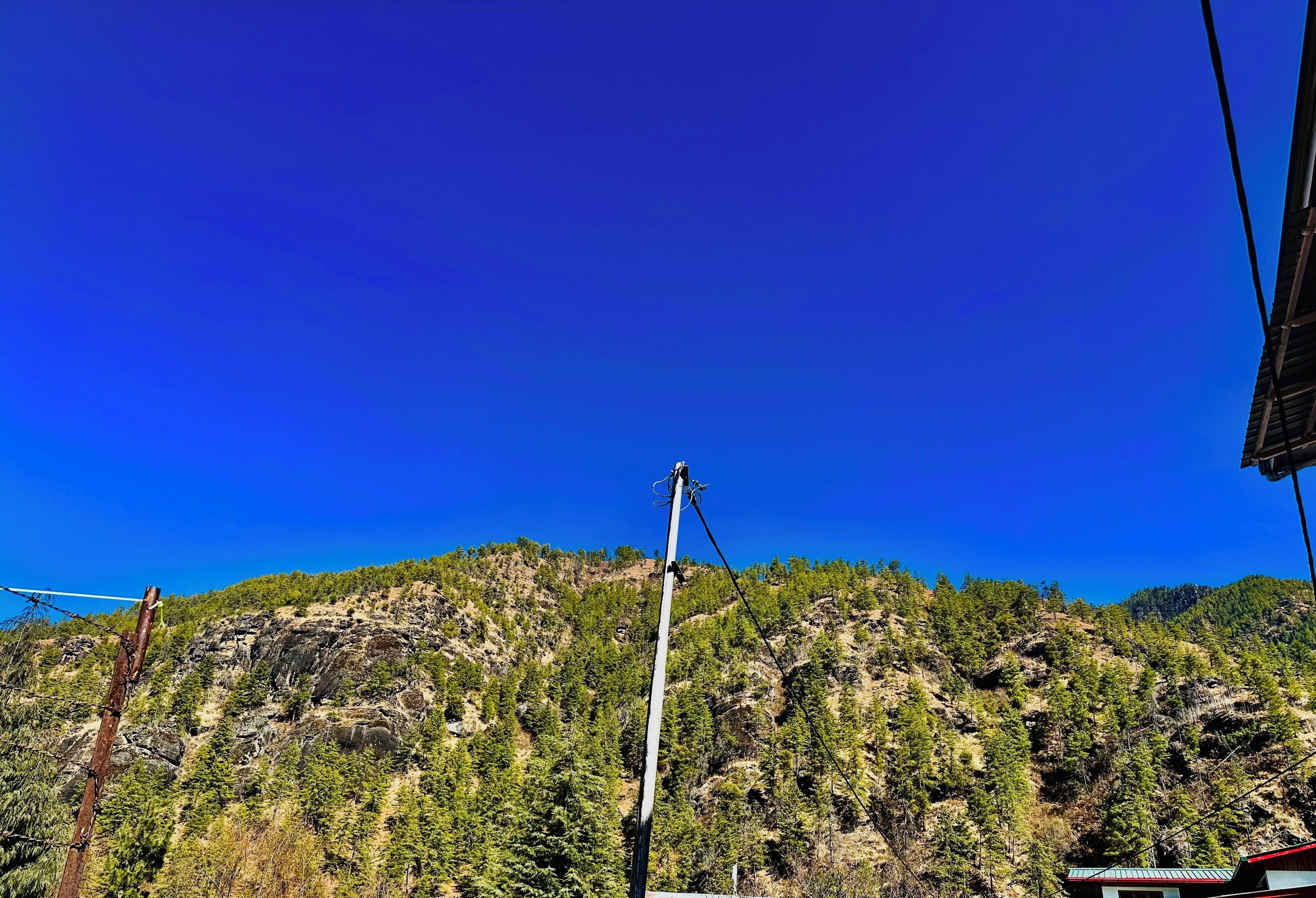 A mountainous landscape with a clear blue sky.