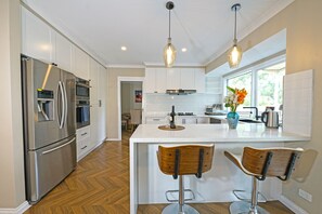 Elite Villa | Private kitchen | Full-size fridge, microwave, oven, stovetop