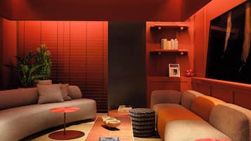 A modern living room with a sectional sofa, a small coffee table, and a bookshelf.