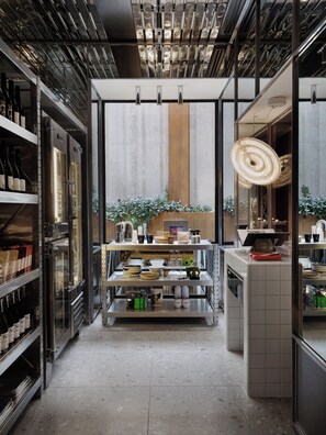 A modern kitchen with stainless steel appliances, glass cabinets, and a central island with a hanging light fixture. - The StandardX, Melbourne (Fitzroy)