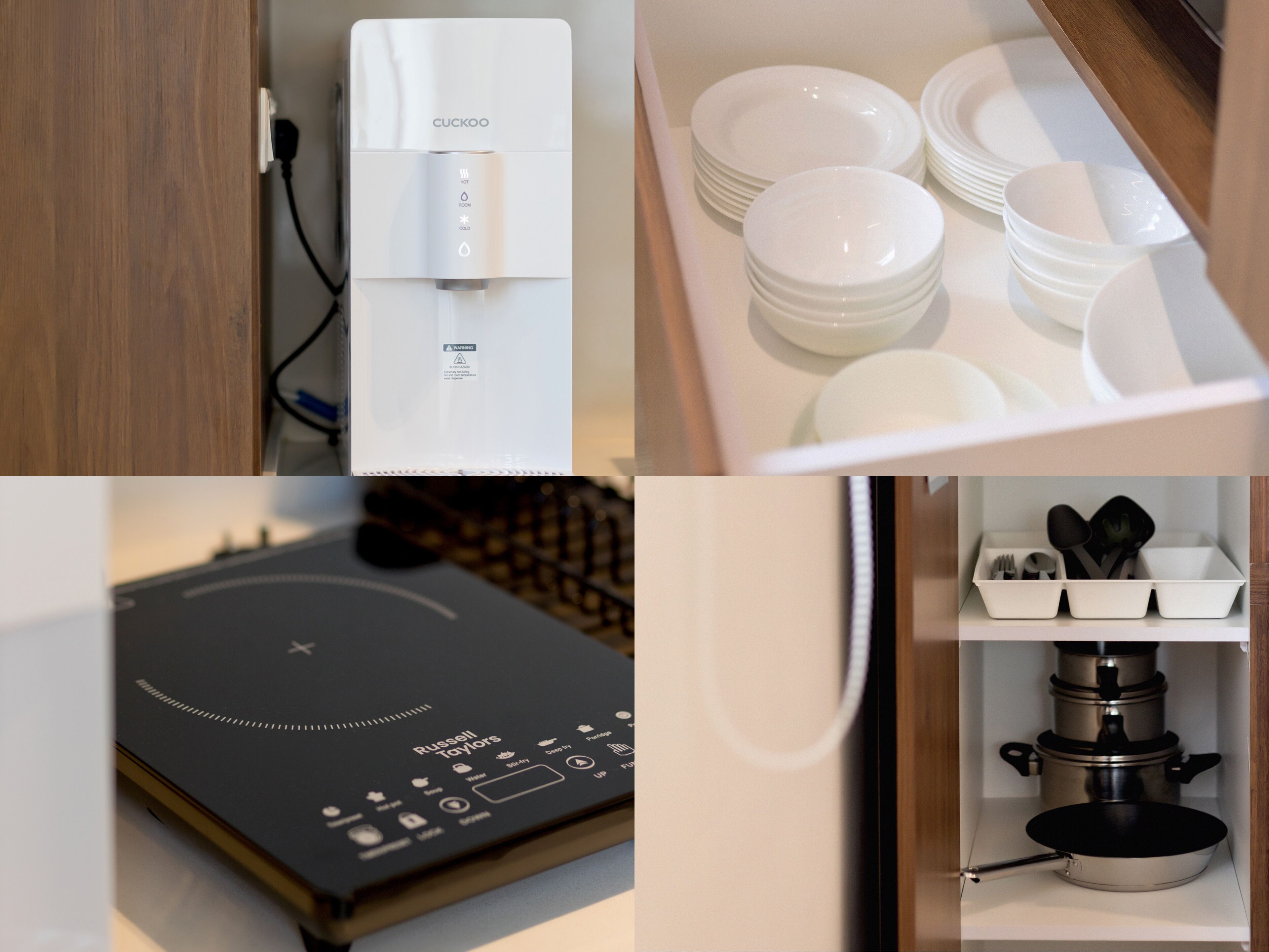 A kitchen with a water dispenser, stacked plates, a black induction cooktop, and a pot rack.
