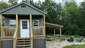 A small cabin with a front porch, a covered deck area, and outdoor seating. - FS Rental #4 Annapolis, MO Black River (Annapolis)