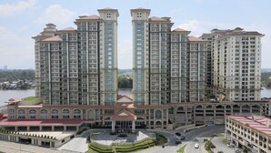 A high-rise residential building with multiple floors, a central courtyard, and a view of a body of water. - Kuching Riverine Resort  (Kuching)