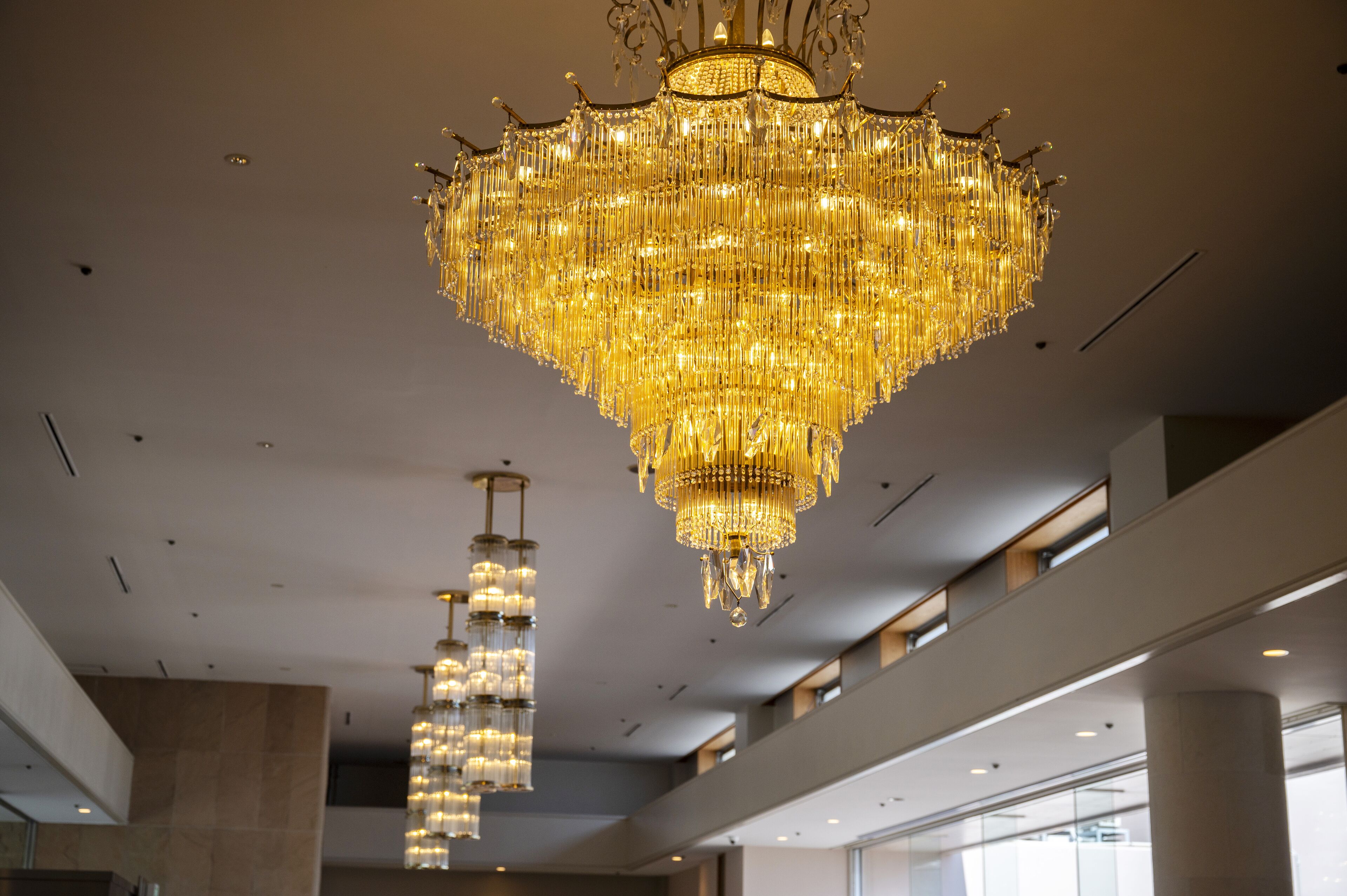 A spacious lobby with a large, ornate chandelier hanging from the ceiling.