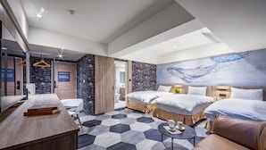 A modern hotel room with a large bed, a desk, and a seating area. - modayhotel (Taichung)