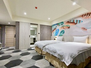A modern hotel room with a large bed, a bathroom with a mirror, and a geometric-patterned floor. - modayhotel (Taichung)