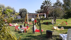 A playground with swings, slides, and tables. - Apartment 'Agriturismo Heaven Trilocale 1' with Mountain View, Shared Pool and Wi-Fi (ricadi)