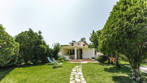 A house with a stone pathway leading to a door, surrounded by lush greenery and a hammock. - Holiday Home "Villa Margherita" with 2 Private Terraces and Wi-Fi (Geremeas)