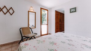 A bedroom with a bed, a chair, a window, and a door. - Holiday Home "Villa Margherita" with 2 Private Terraces and Wi-Fi (Geremeas)